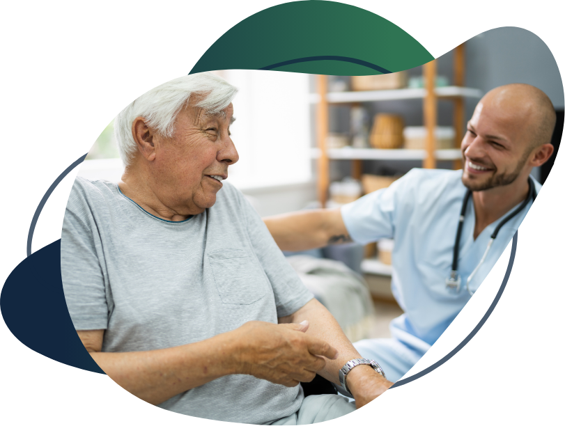 Male travel nurse laughing with elderly patient